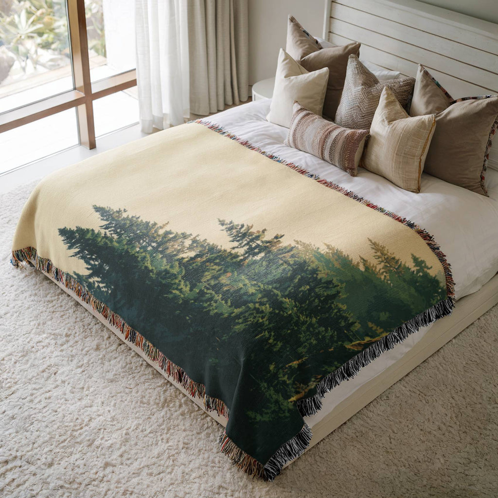a large bed with a forest scene on it