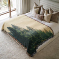 a large bed with a forest scene on it
