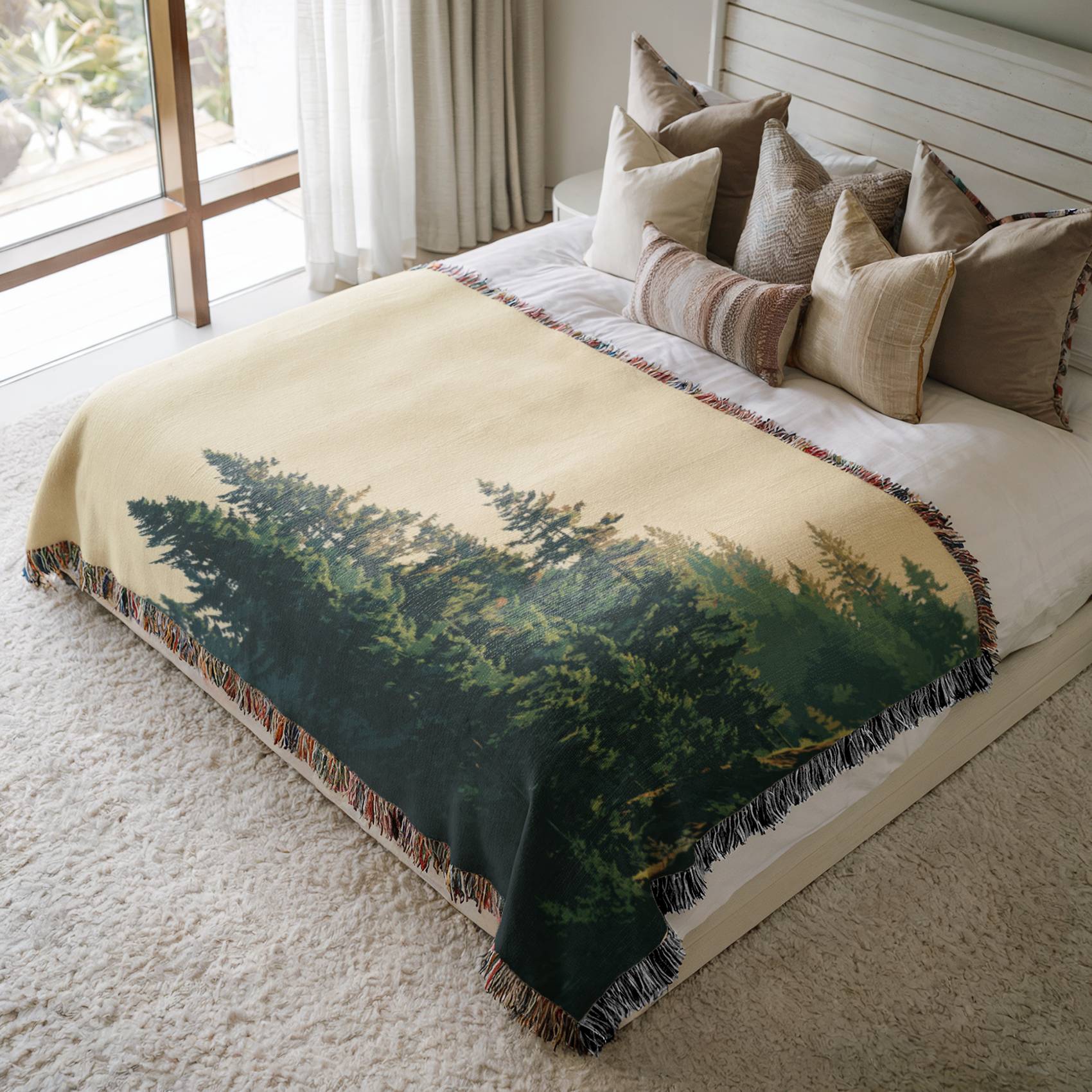 a large bed with a forest scene on it