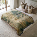 a bed with a blanket and pillows on top of it