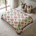 a bed with a blanket and pillows on top of it