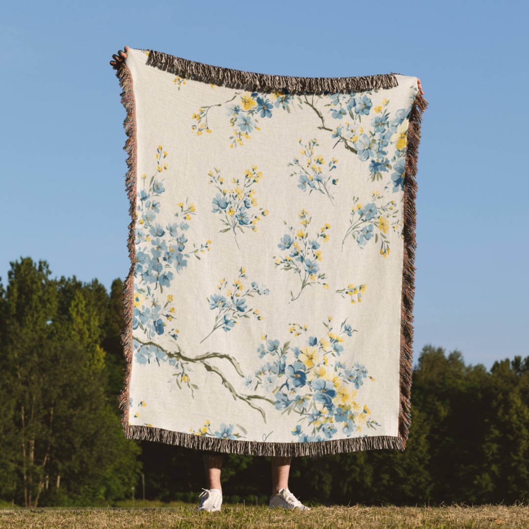 a person standing in a field holding a blanket