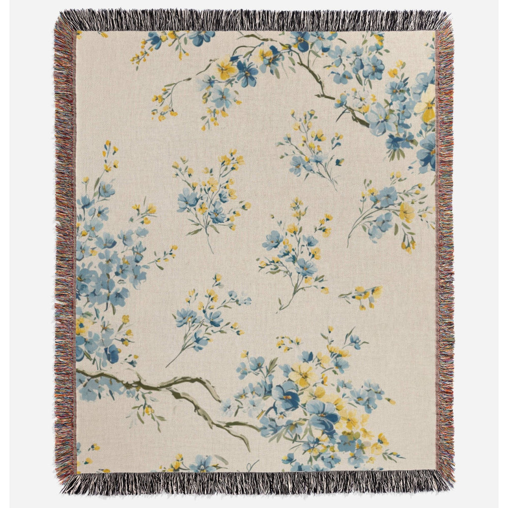 a blue and yellow flowered blanket with fringes