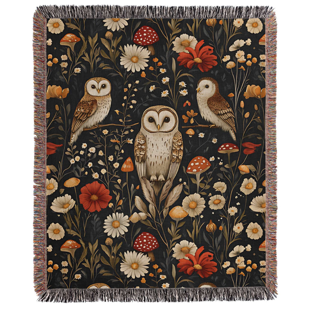 a tapestry with two owls and flowers on a black background