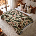Evergreen & Berries jacquard woven blanket on a queen bed