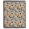 a blanket with trees and leaves on it