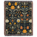 a tapestry with flowers and leaves on a black background