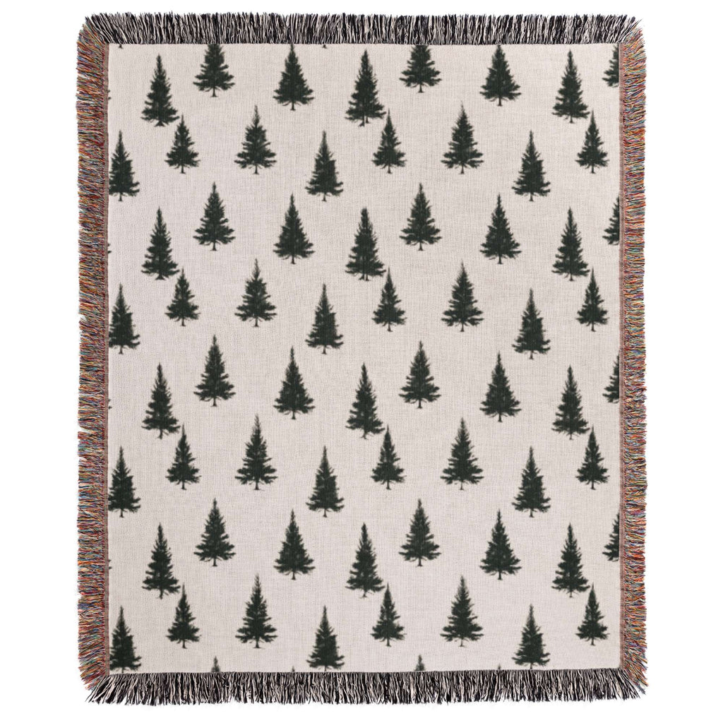a white blanket with black trees on it