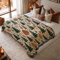 Woodland Canopy jacquard woven blanket on a queen bed