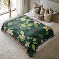 a bed with a green and yellow blanket on top of it